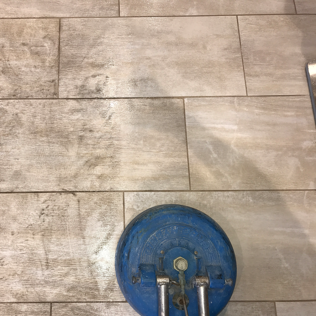 Image of a tiled floor being cleaned